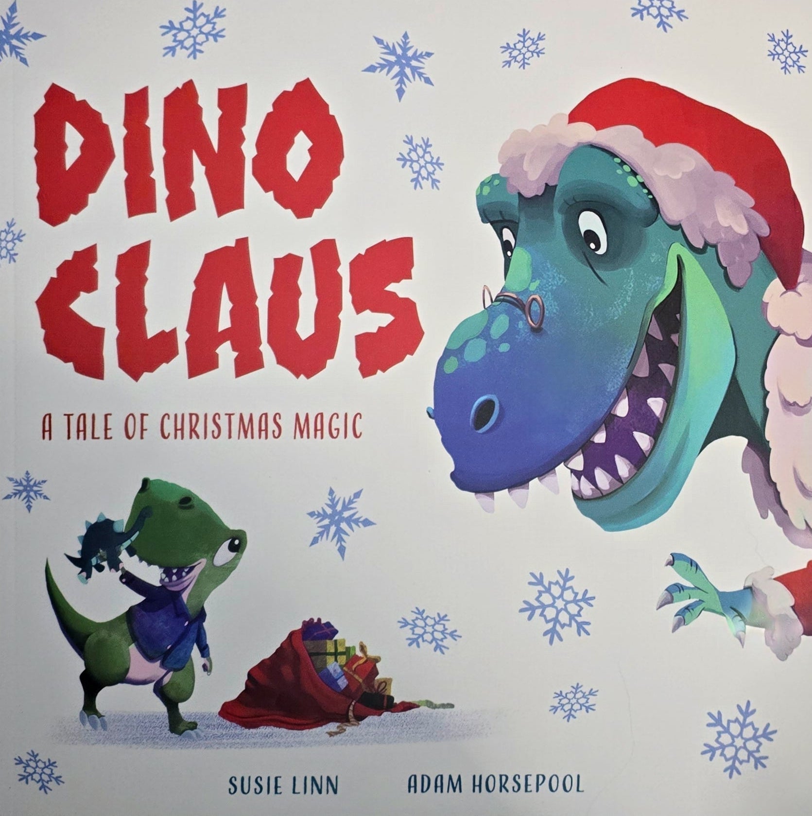 Book cover of 'Dino Claus' with a dinosaur character wearing a Santa hat and snowflakes on the background.
