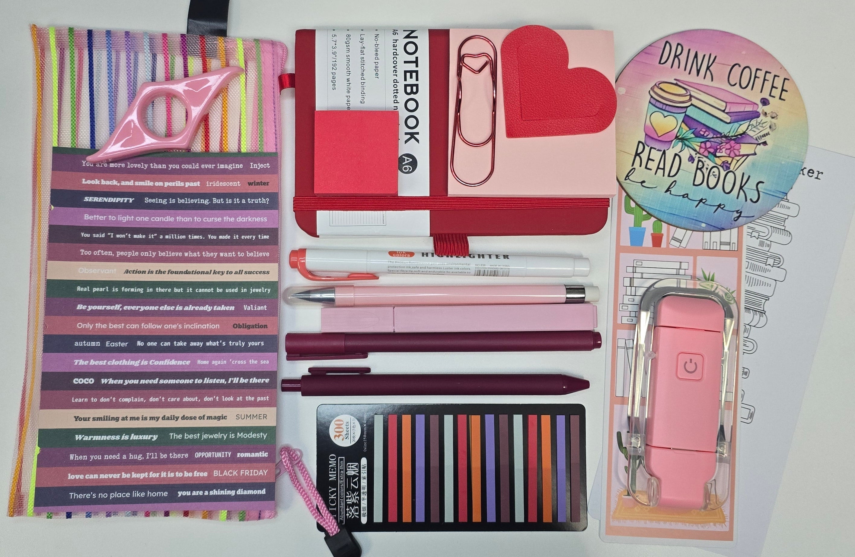 Stationery items including pens, notebooks, and a ruler on a white background