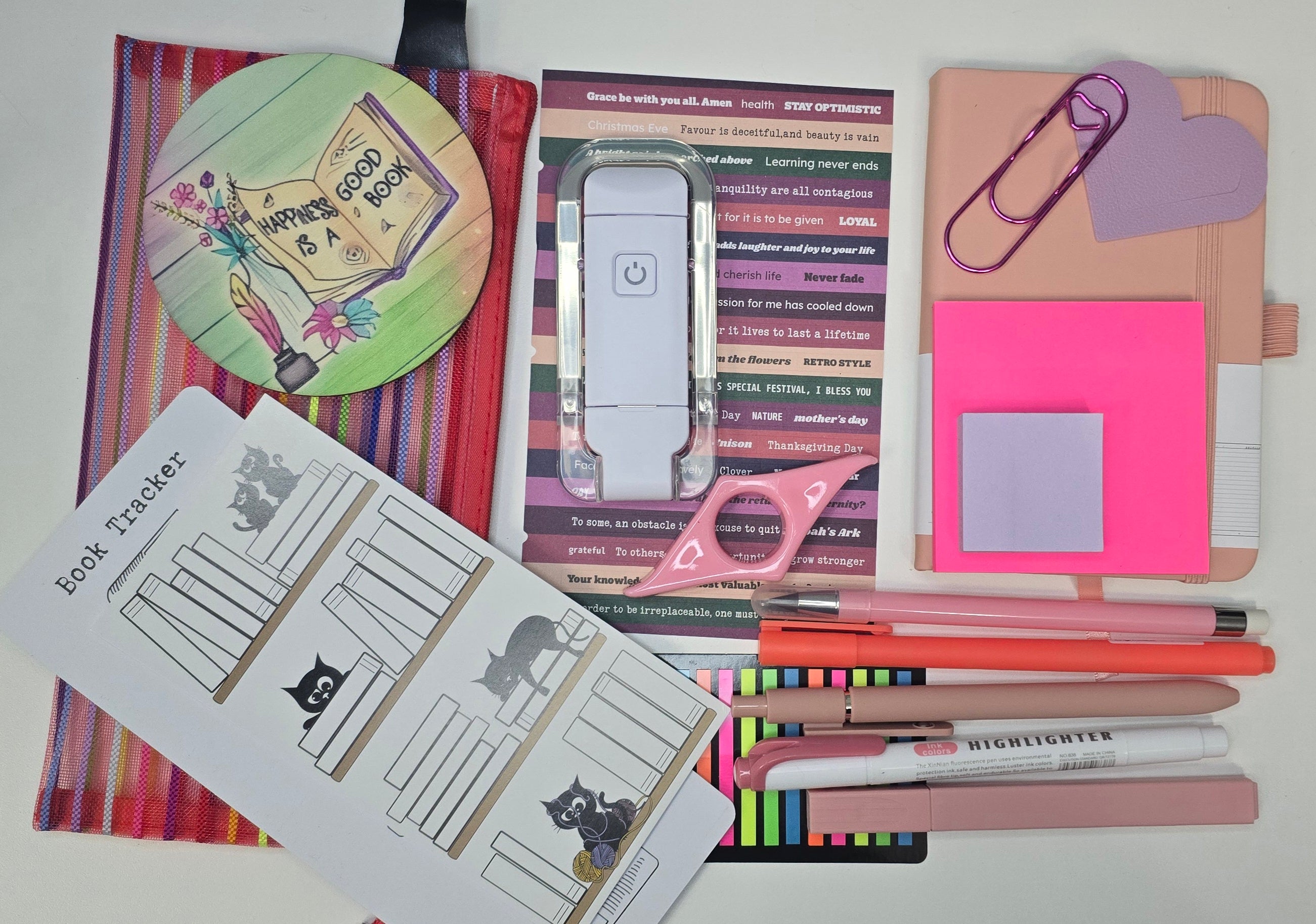 Collection of stationery items including a notebook, bookmarks, and highlighters on a white background