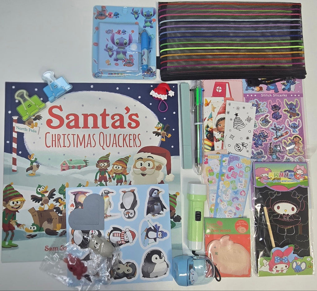 Collection of children's items including books, stickers, and a flashlight on a white surface.