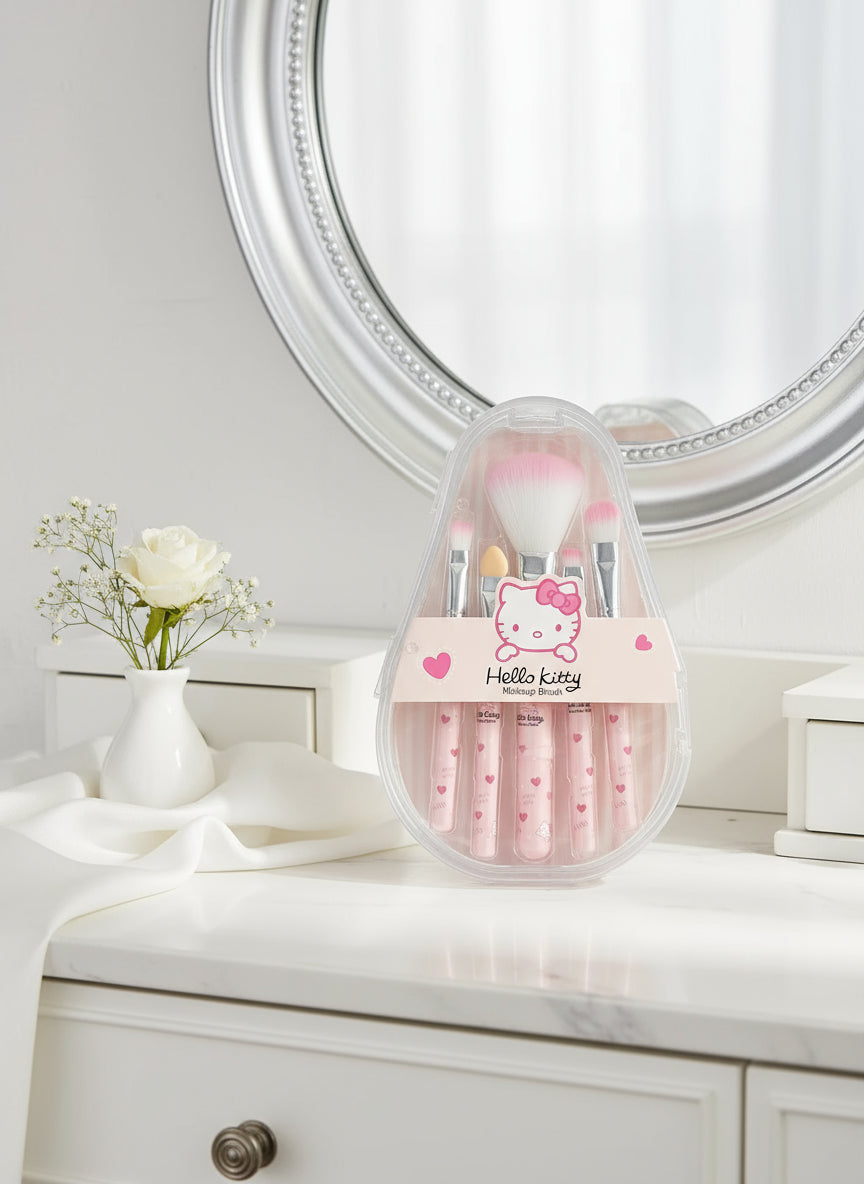 Set of makeup brushes with a Hello Kitty case on a textured surface