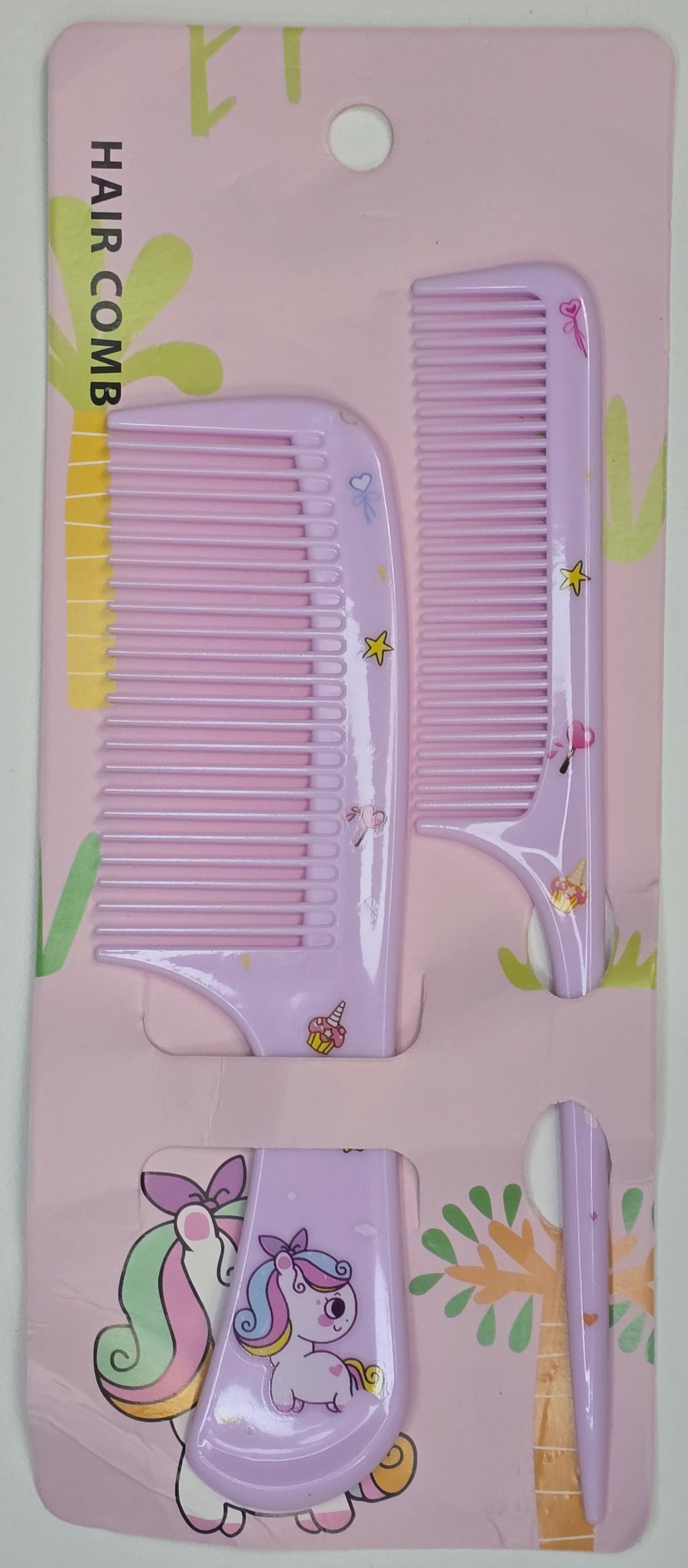 Set of hair combs on a pink card with cartoon designs