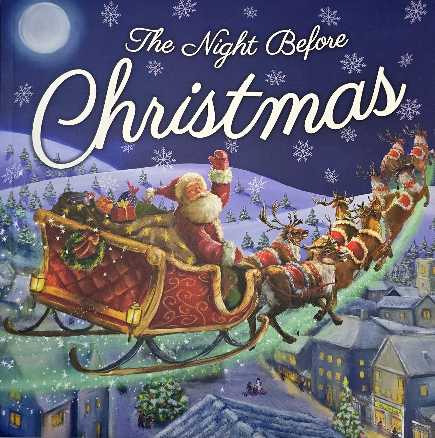 Cover of 'The Night Before Christmas' with Santa Claus and reindeer sleigh on a snowy night.