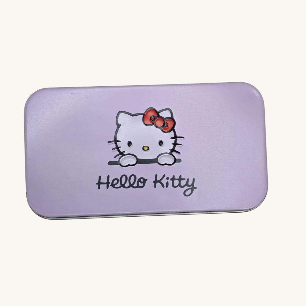 Closed purple Hello Kitty makeup brush tin on an ivory background
